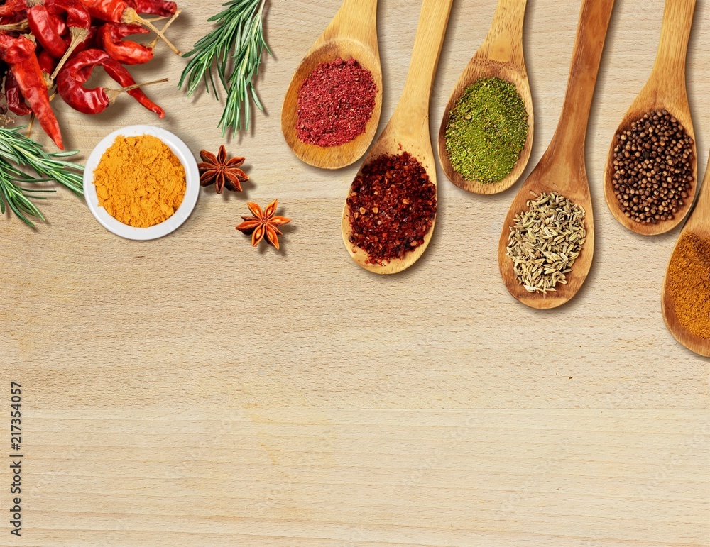 Various colorful spices on wooden table