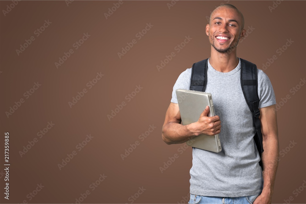 Male student with  backpack on background