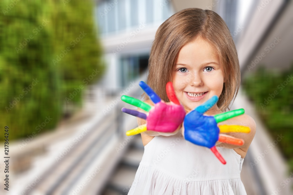 Cute little girl with colorful painted hands