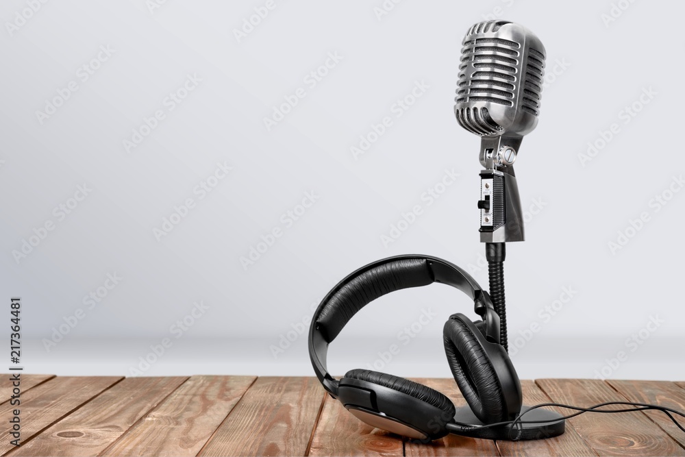 Retro style microphone and headphones on  background