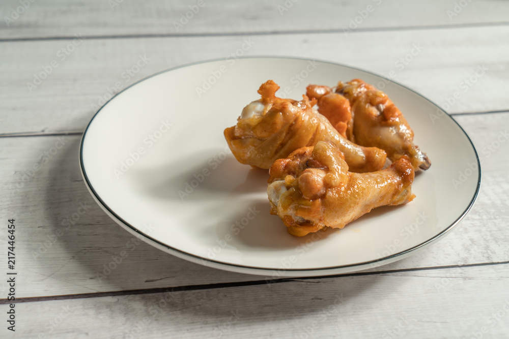 Roast chicken wring on the wooden table