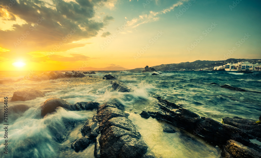 Beautiful seascape with rocks and waves at sunset