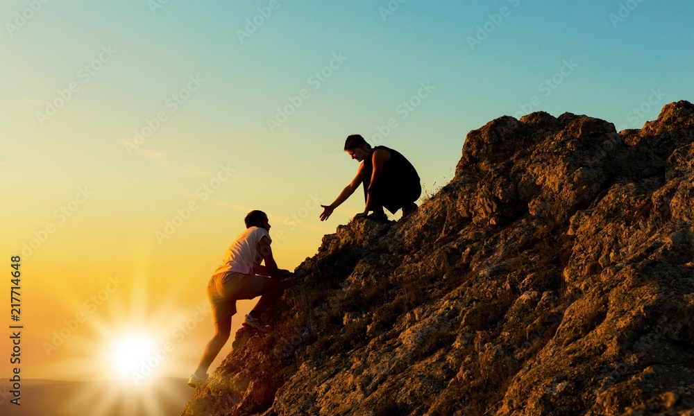 Man Rock Climbing with another, Man Helping concept