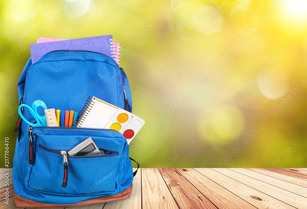 School bag on wooden desk