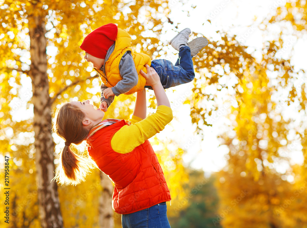 happy family  mother   and baby son on   autumn walk