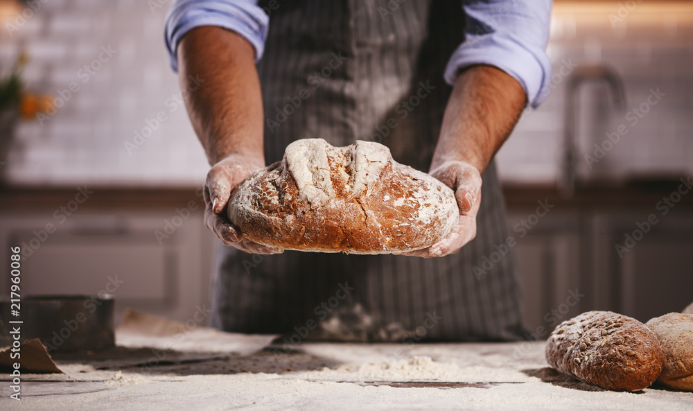 hands of bakers male knead dough