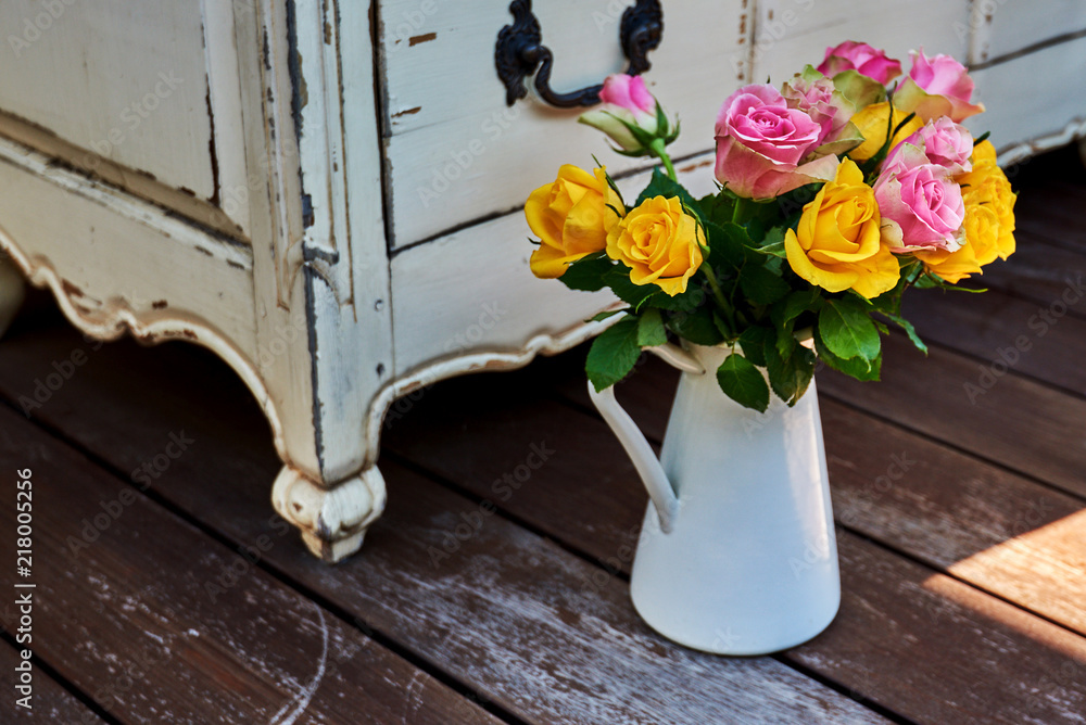 Beautiful bouquet of  roses on the background vintage furniture.