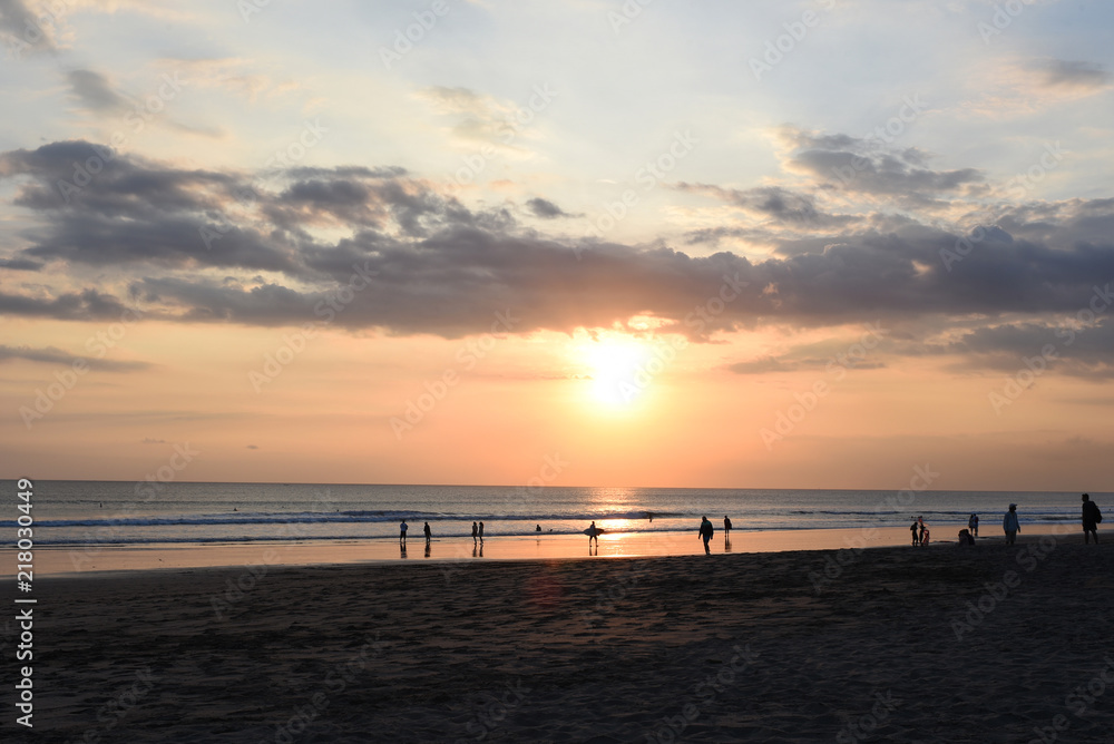 Silhouette group of people on the beach at golden sunset time, summer concept.