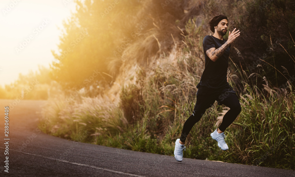 Man running fast on mountain road