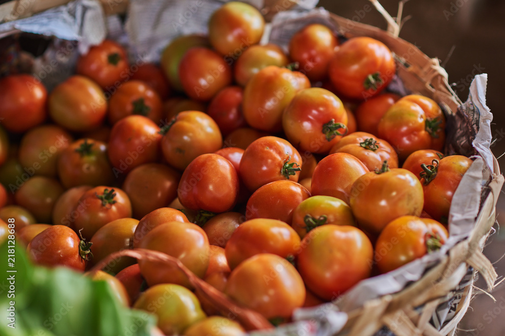 Tomatoes in basket - fresh food market. Healthy fresh vegetables on sale at the local farmers market