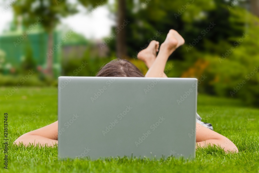 Portrait of a Young Woman Using her Laptop in a Park