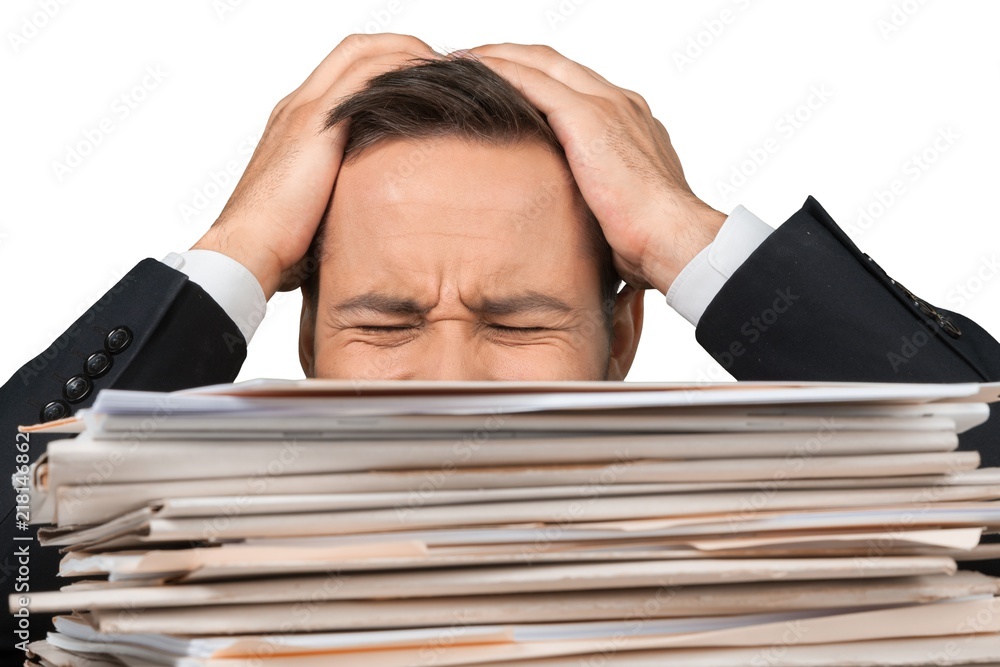 Closeup of an Exhausted Employee Behind Stack of Folders