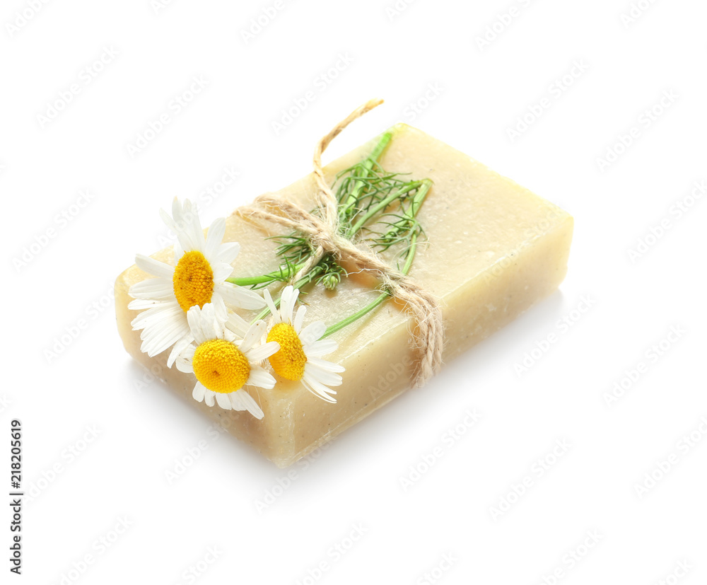 Natural soap with chamomile flowers on white background