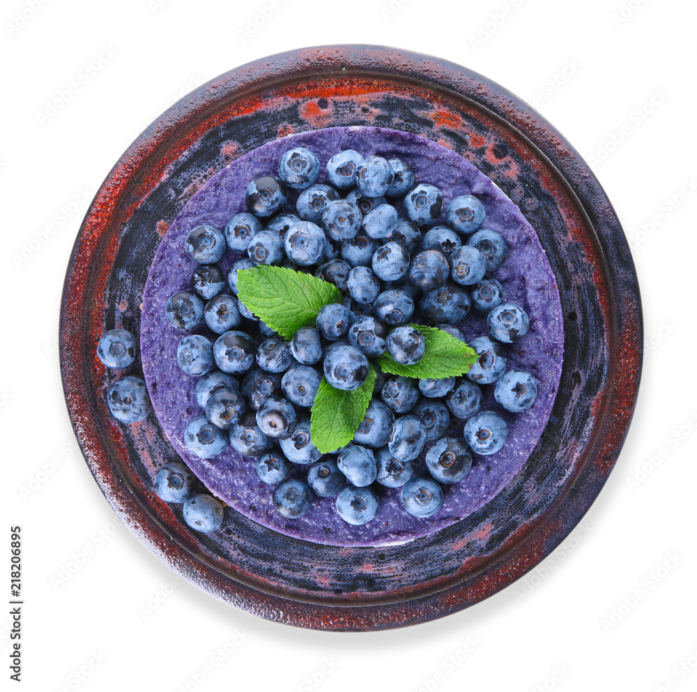 Plate with delicious blueberry cheesecake on white background, top view