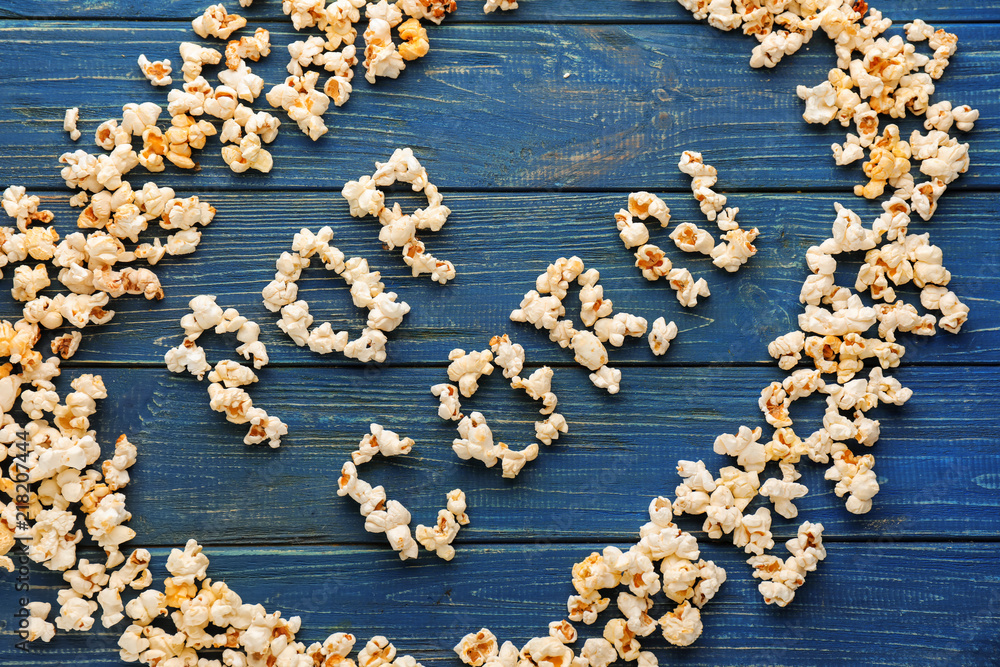 Words made of delicious popcorn on wooden table