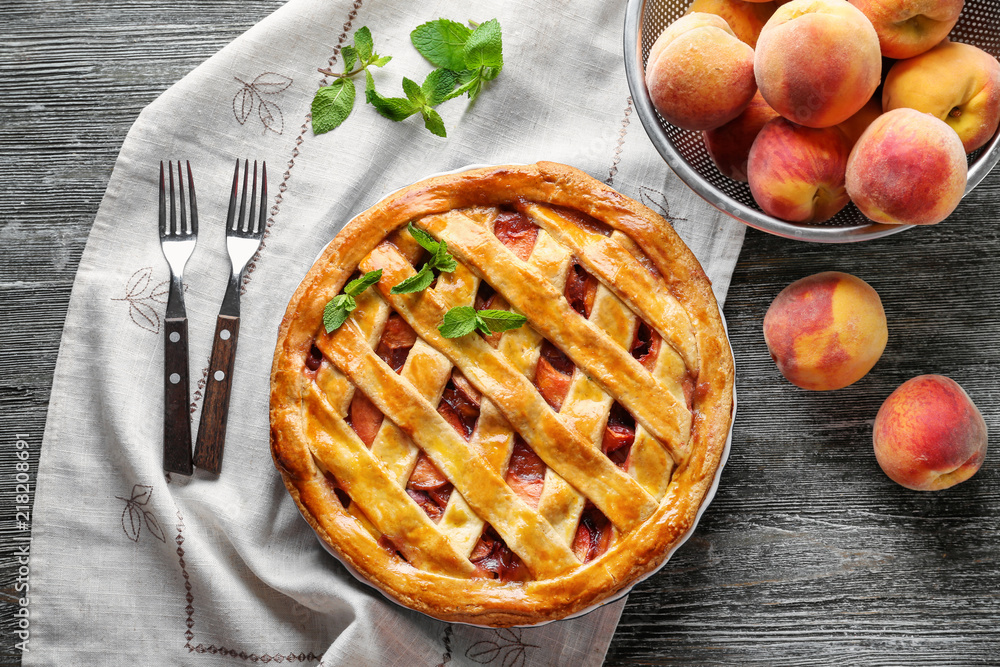 Delicious peach pie on wooden table