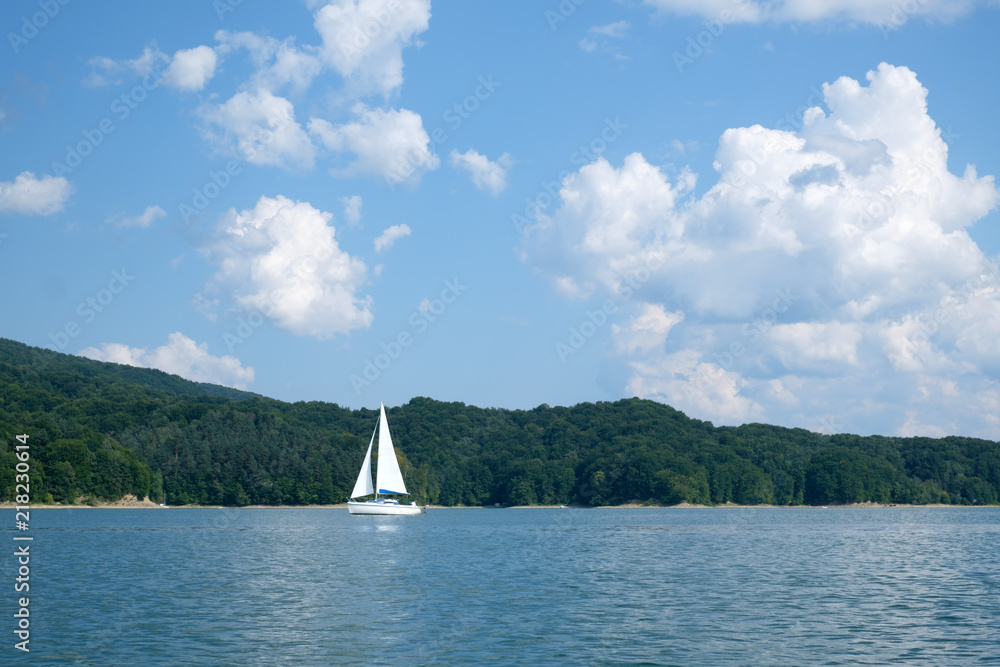 White yacht on Solina lake, Poland. Landscape photography