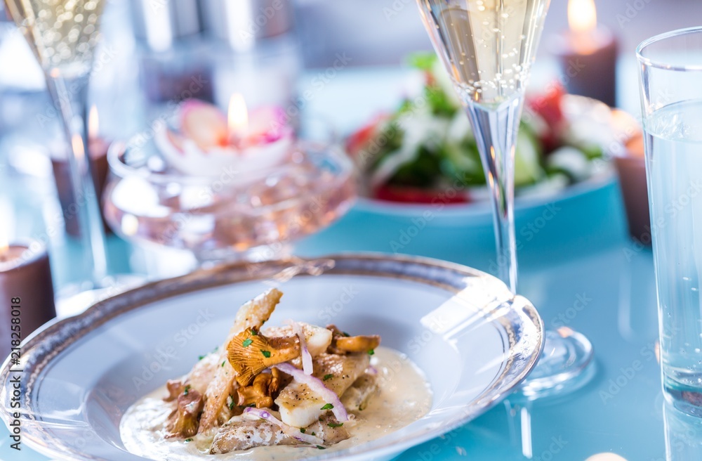 Close-up of Table with Food, Plates, Candles and Champagne