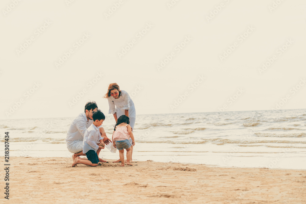 Happy family goes vacation on the beach in summer.