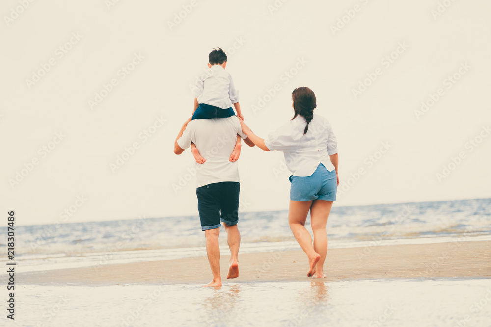 Happy family goes vacation on the beach in summer.