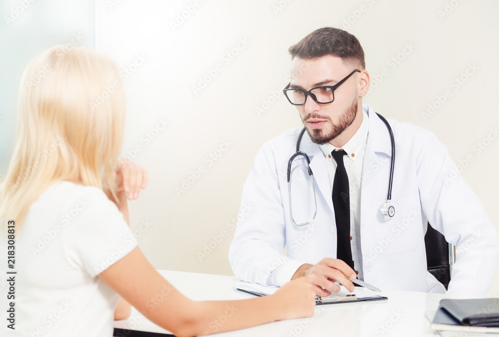 Male Doctor and Female Patient in Hospital Office