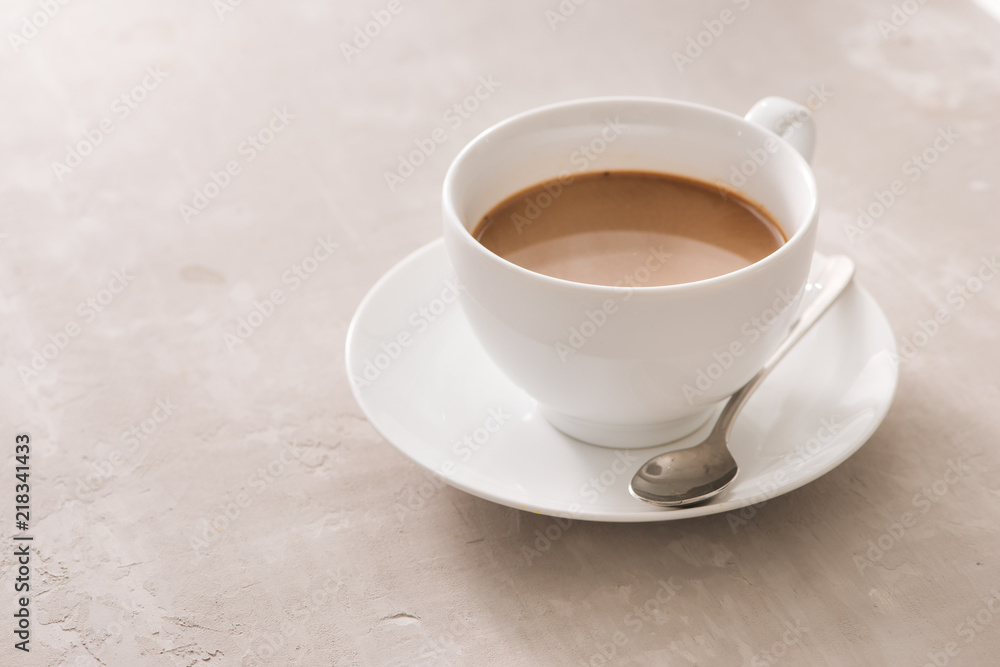 White china cup of tea with milk on a plain background