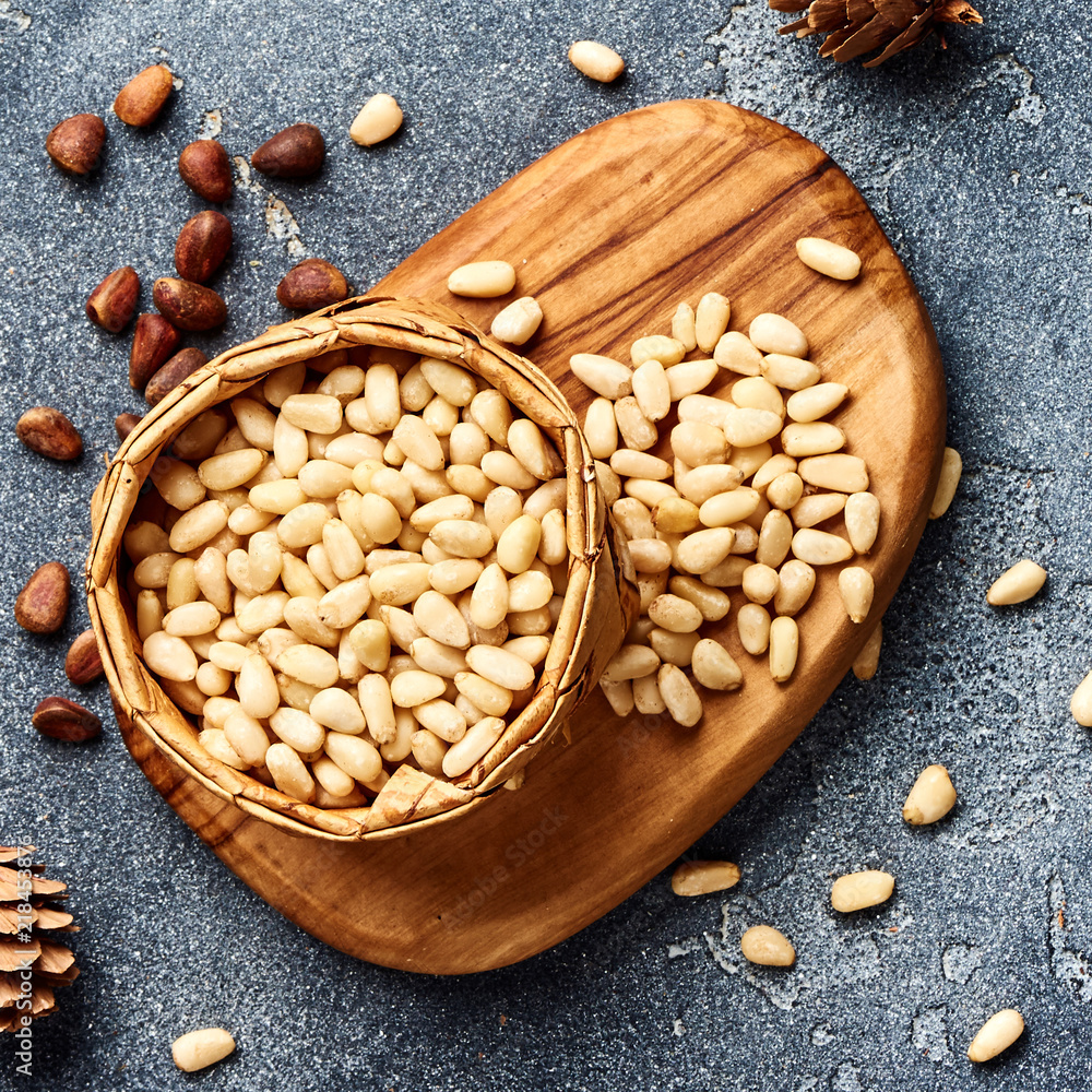 Peeled pine nuts on gray background. Top view.