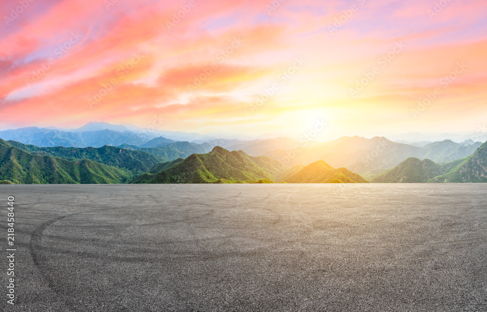 Empty asphalt square car tire brakes and mountain scenery at sunrise