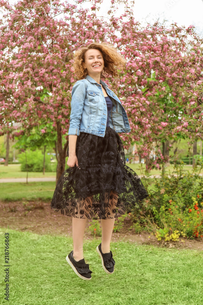 Carefree woman having fun in spring park