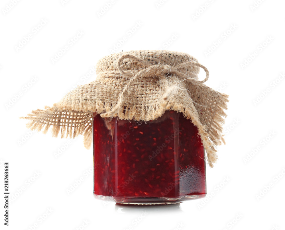 Glass jar with raspberry jam on white background