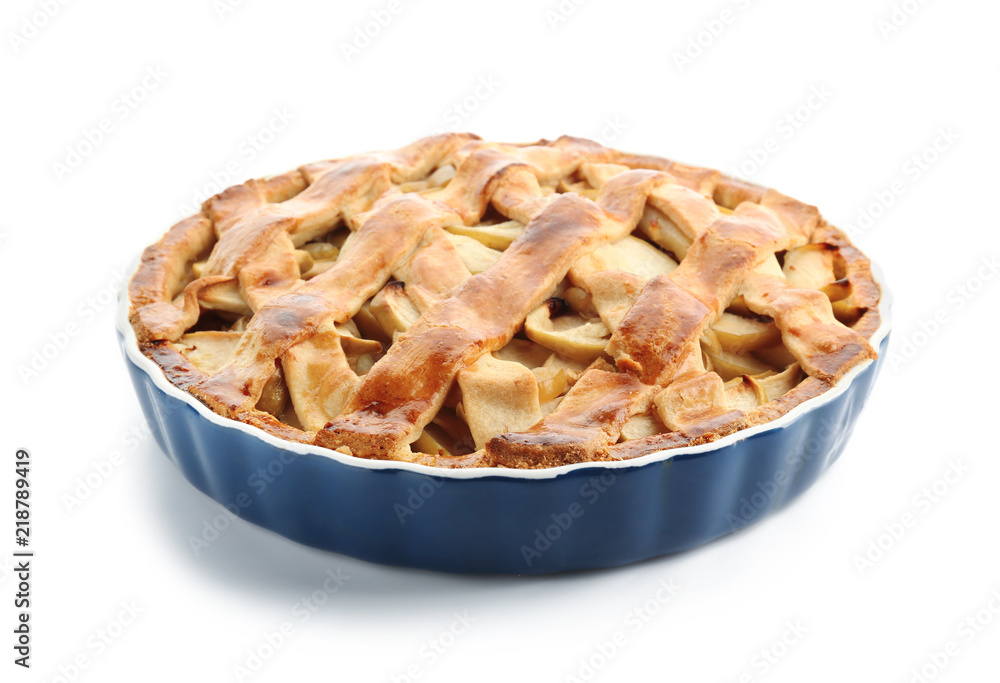 Dish with delicious apple pie on white background