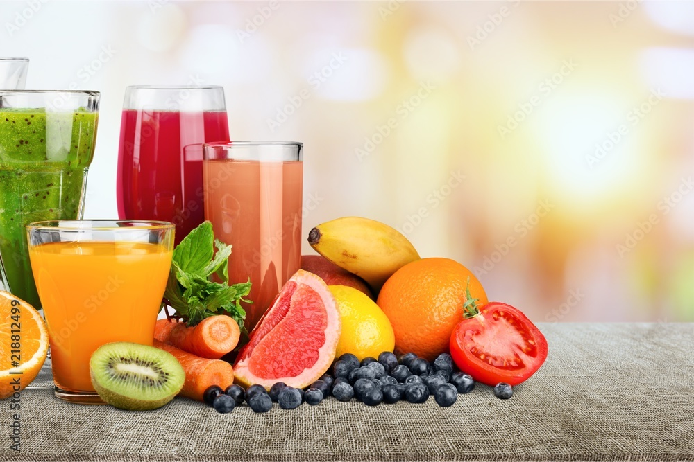 Fresh ripe healthy fruits and juices in glasses