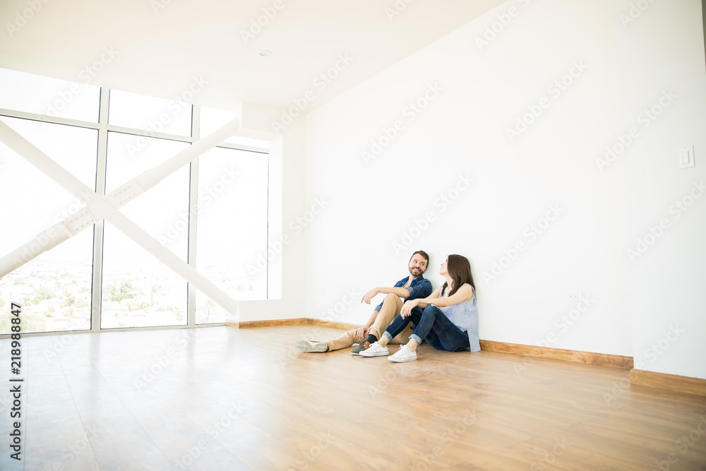 Man Talking With Woman In Empty Room Of New House