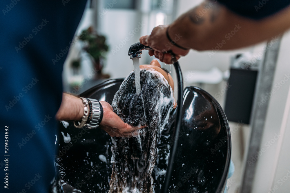 Hair washing at a hairdressing salon. Close-up.