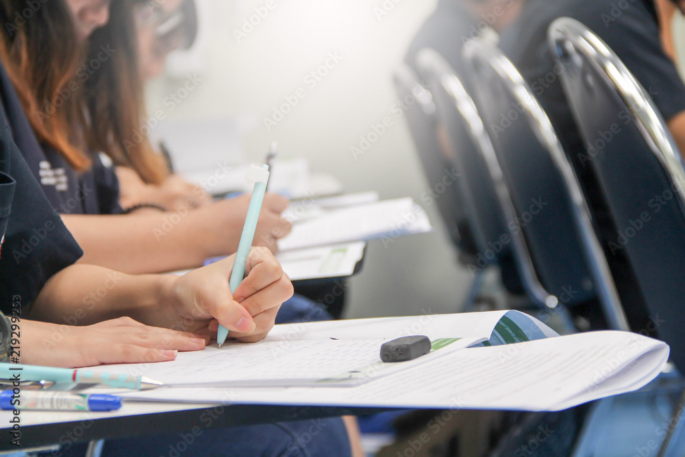 Hands university student holding pen writing /calculator doing examination / study or quiz, test fro