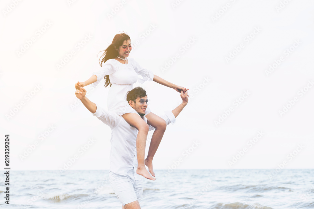 Couple going honeymoon on tropical beach in summer