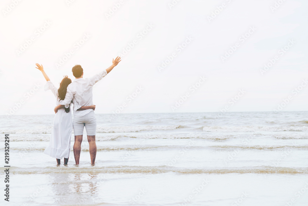 Couple going honeymoon on tropical beach in summer