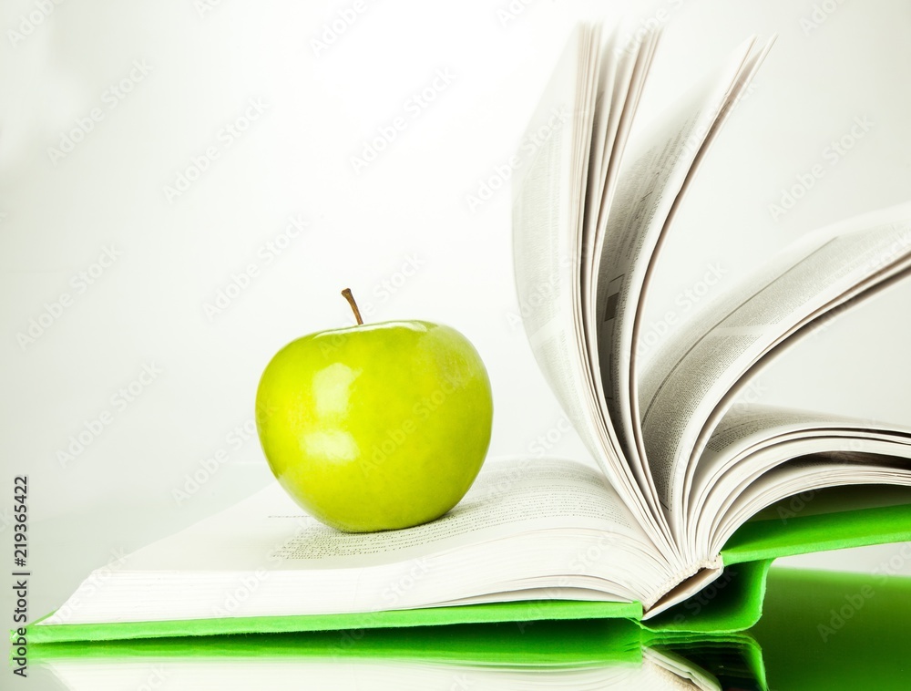 Green Apple On Open Book Close-up