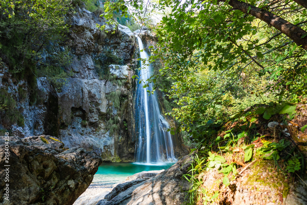 beautiful view of the waterfall hidden in the forest