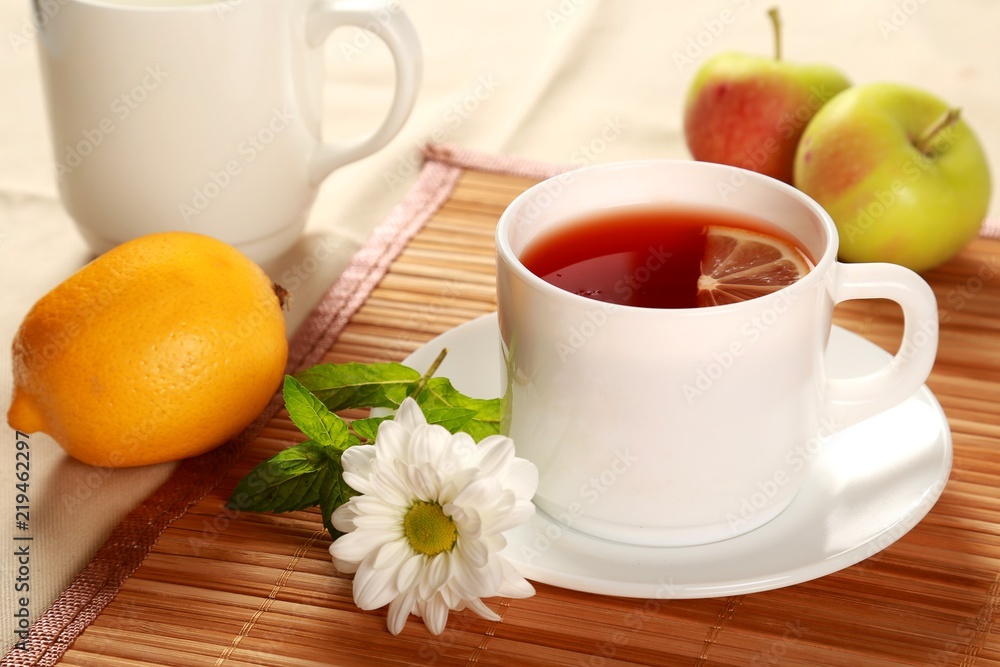 Tea with lemon slice fruit and a flower