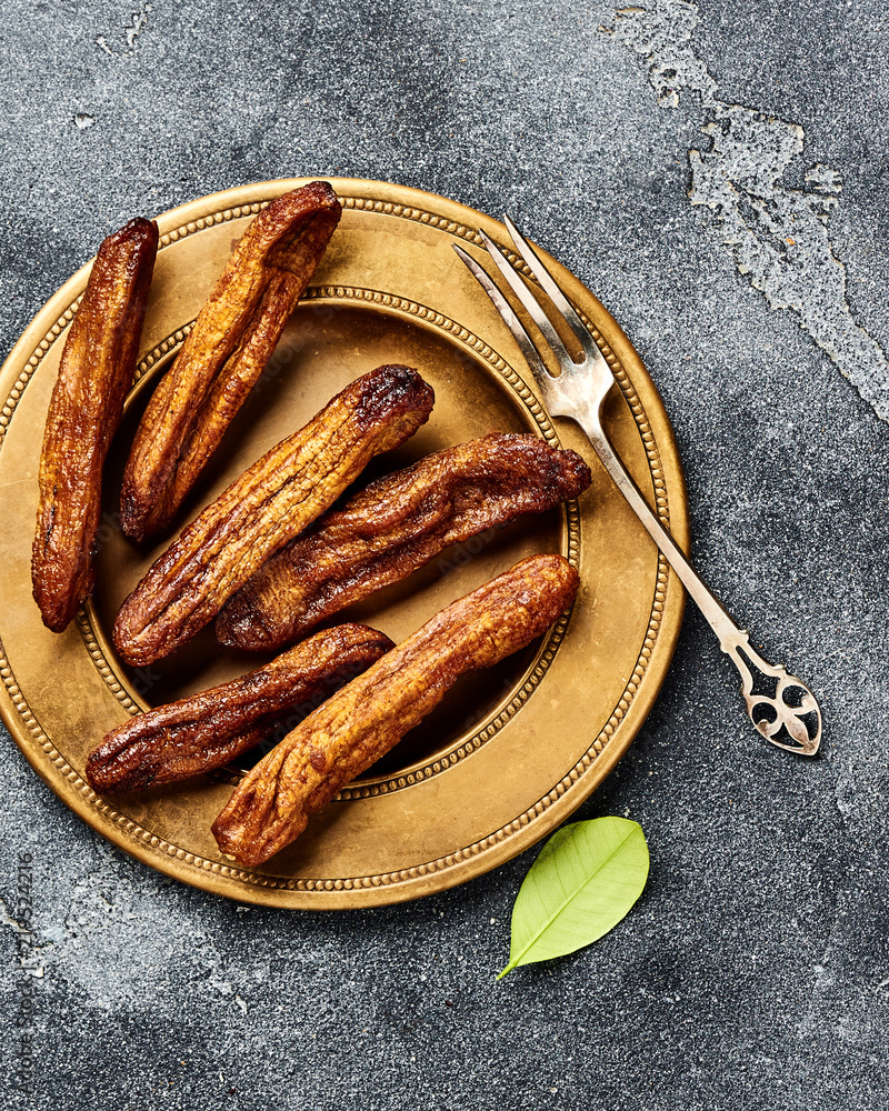 Dried bananas on gray background. Top view.