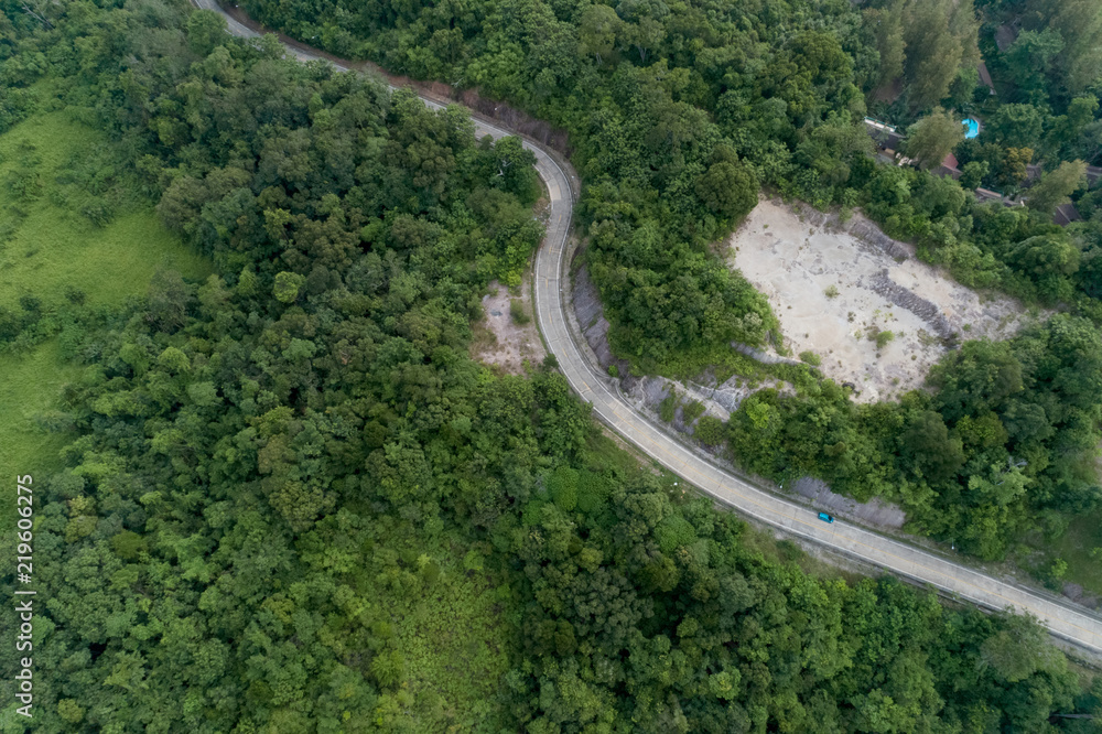 Aerial view from drone of curve road on the mountain with green forest in phuket thailand.