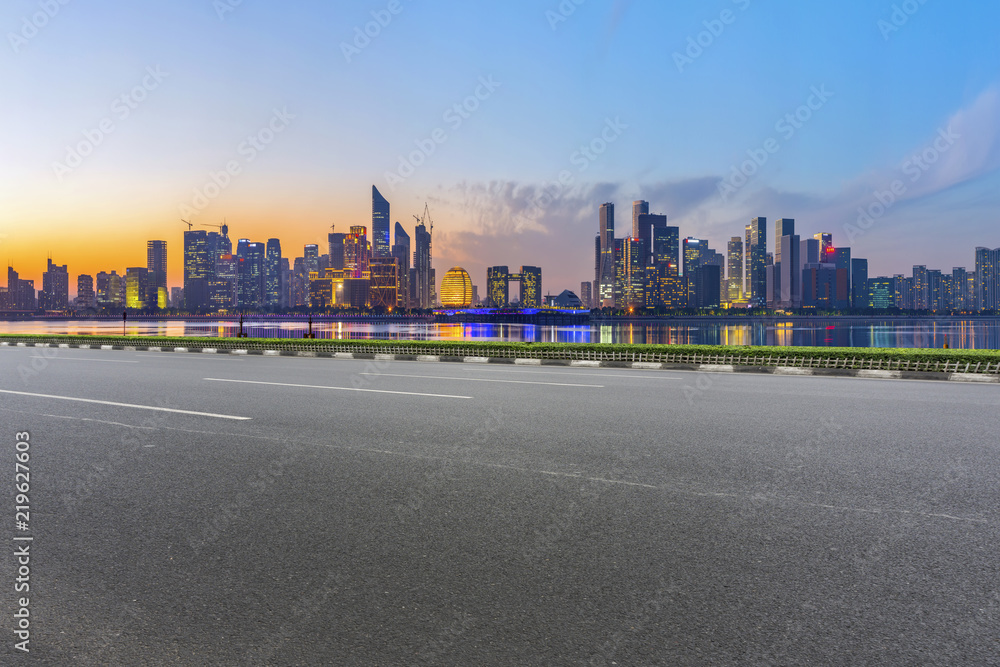 Urban road asphalt pavement and skyline of Hangzhou architectural landscape