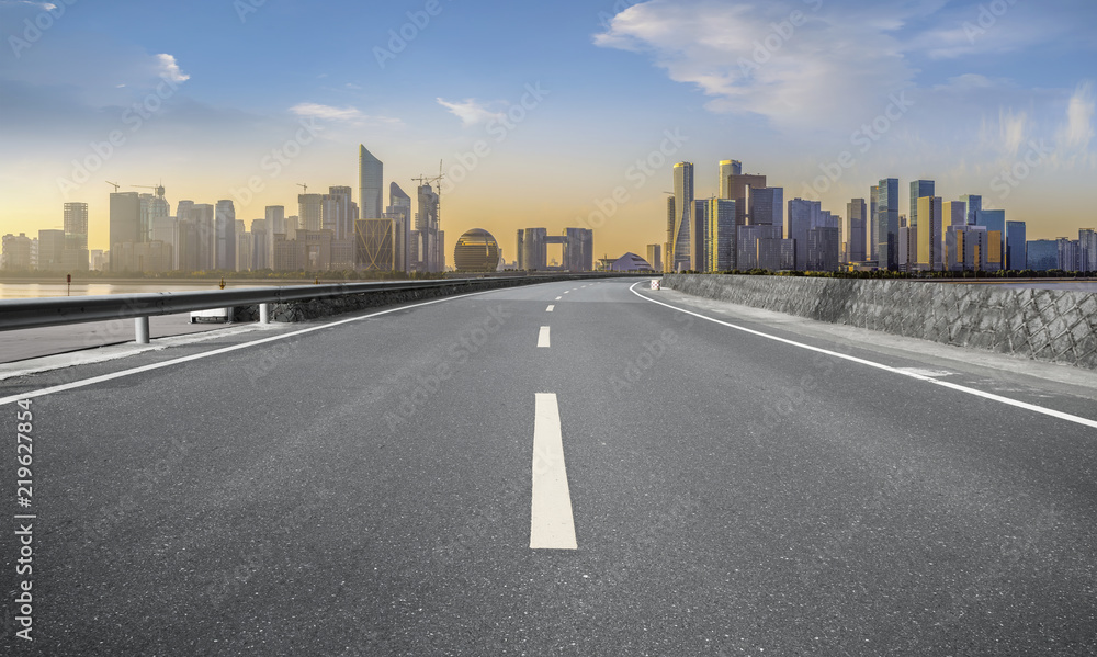 Urban road asphalt pavement and skyline of Hangzhou architectural landscape