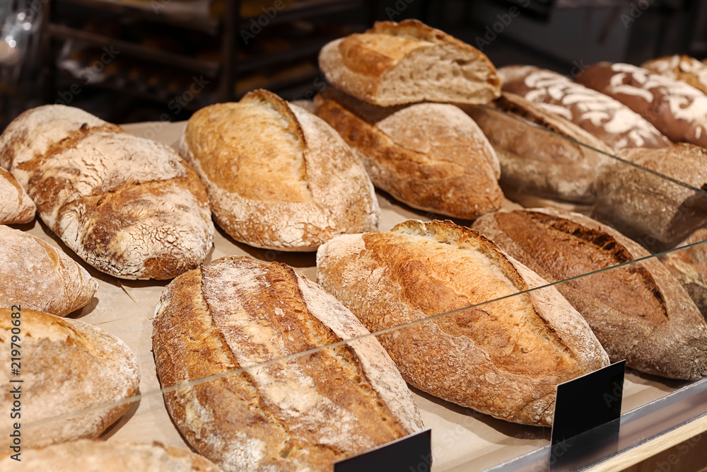 Delicious fresh bread on shelf in bakery