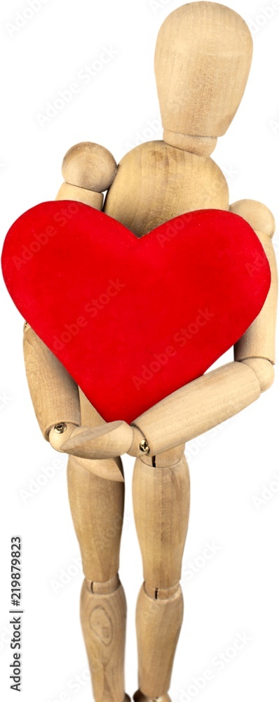 Wooden mannequin holding a heart