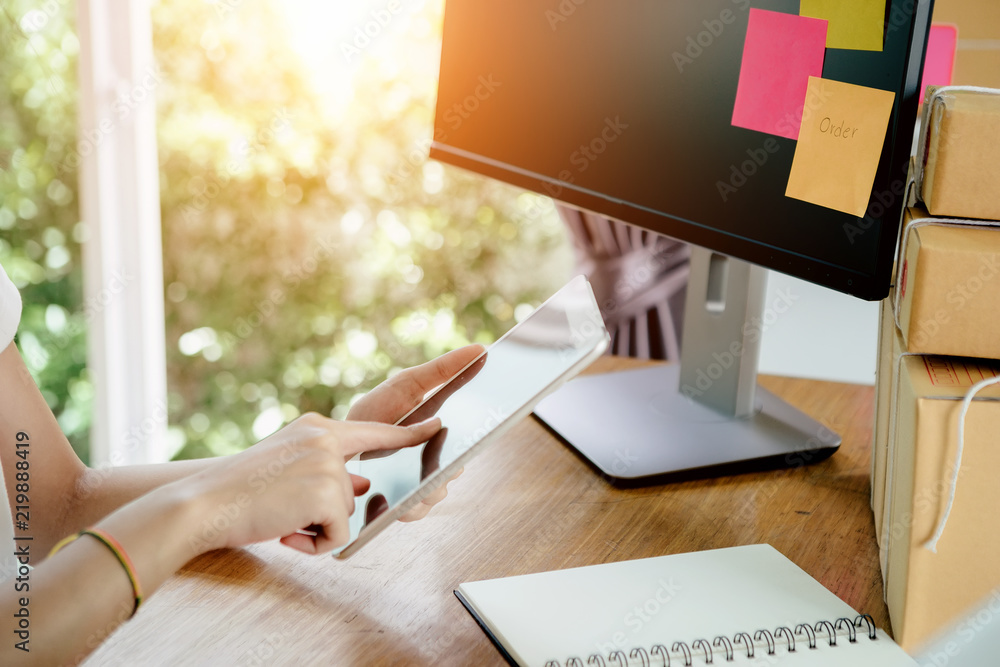 Young asian girl is freelancer with her private business at home office, working with laptop, coffee