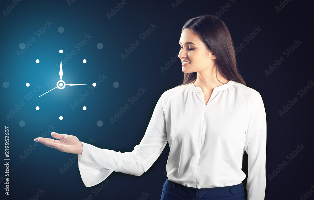 Young businesswoman holding something on black background