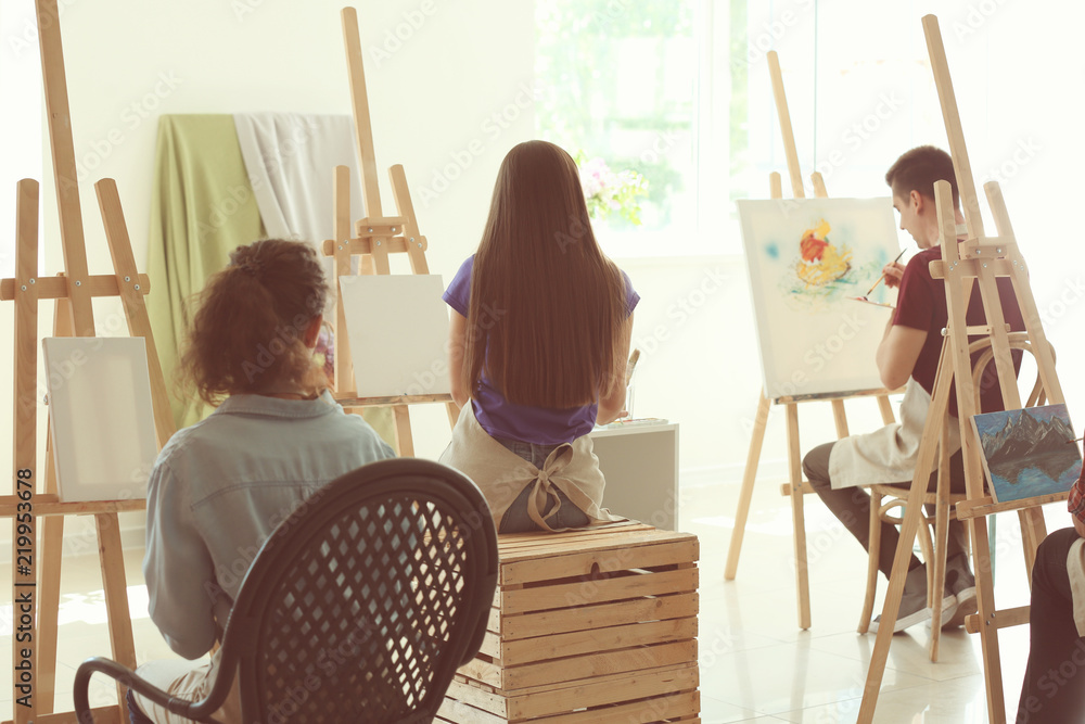 Group of people during classes in school of painters