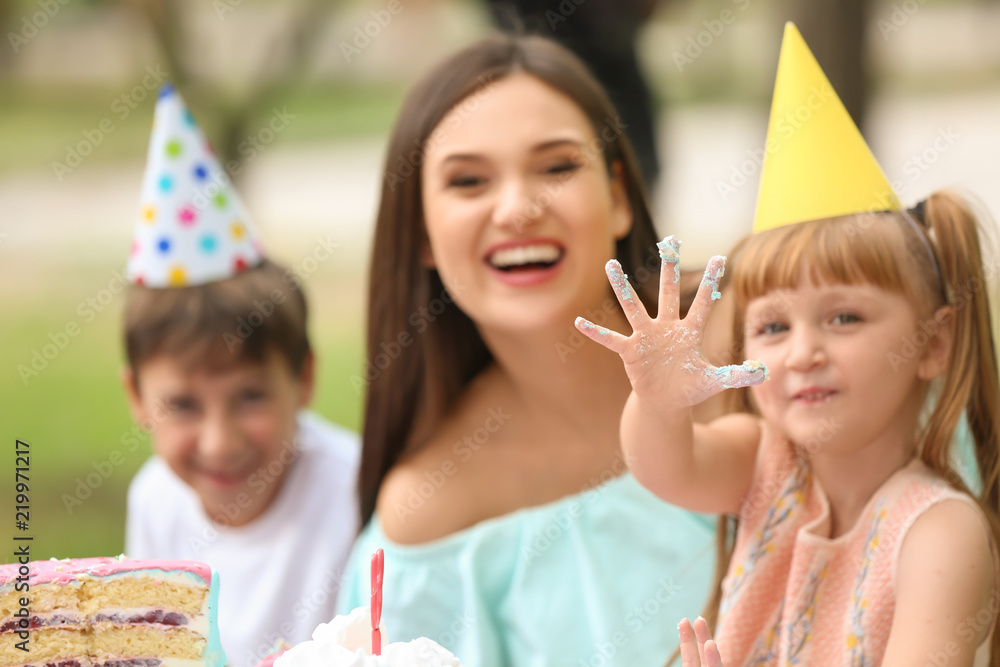 可爱的小女孩和家人在户外生日聚会